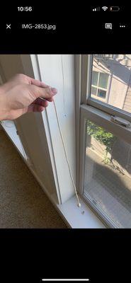 The pull string on the blinds was detached and laying on the windowsill