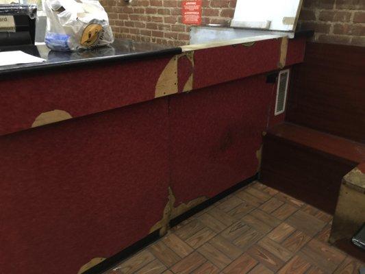 The counter as you walk in. Crumbling. The staff doesn't care. Photo by Paul Klenk.