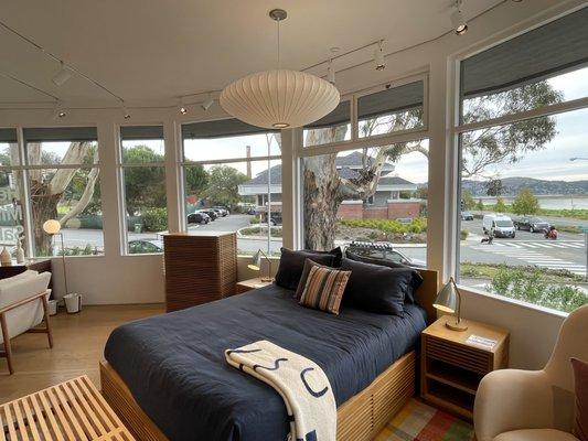 Large Eames lamp over a queen size bed.