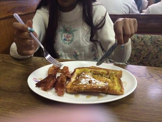 My daughter's two-stack French toast with bacon and powdered sugar $5.00,