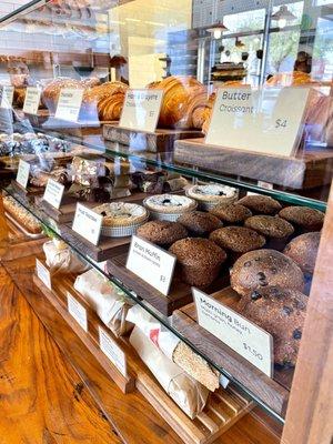 Pastry case with Butter Croissant, Chocolate Croissant, bran muffins, morning buns, and more.