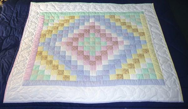 We carry adorable Amish Baby Quilt - this pattern is the traditional Trip Around the World (also called Sunshine and Shadows).