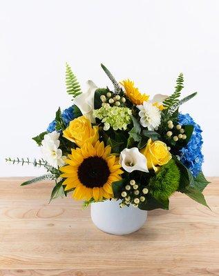 Set Sail - head to the dock and set sail in this crisp white glass vase filled with blue hydrangea, sunflowers, calla lilies, roses, berries