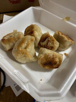 Supposed to be fried dumplings but we got half cooked dough balls seared.