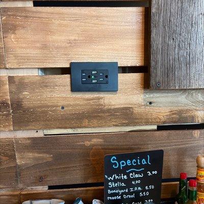 USB and standard outlets at every table along the walls for charging.  Great idea.