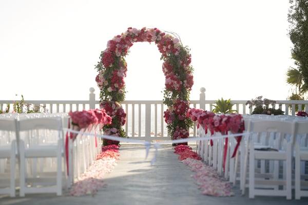 Shutters on the Beach Wedding ceremony with a garden wedding arch.