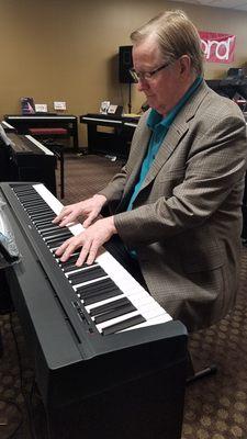 The Owner Rick Backhaus playing a digital piano.