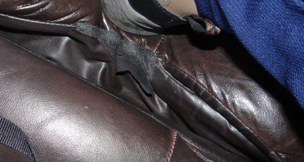 Sofa 1, between cushions, leather seems to be separating