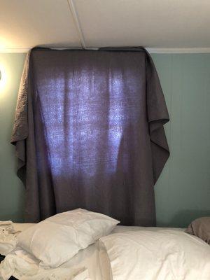 Put bedspread over sheer-window covers