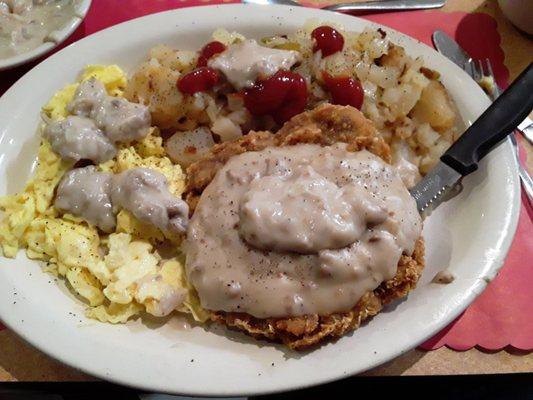 Country Fried Steak with Scrambled Eggs, Home Fries with onions & peppers and Extra Gravy!