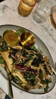 Pla Tod Samun Prai - Fried filet Branzino topped with crispy Thai herb