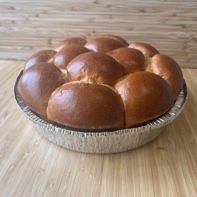 Holiday brioche dinner rolls in a oven safe foil pan.