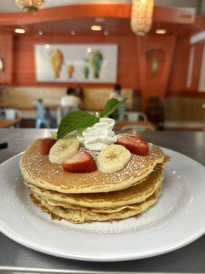 Blai  Pancakes served with banana strawberry and whipped cream