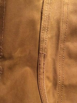 Where the original seam was opened, but not re-stitched.