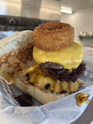 The Dovetail Burger. Two 1/4 pound patties, sandwiched with American cheese and topped with house onion rings and bacon jam. Messy but good!