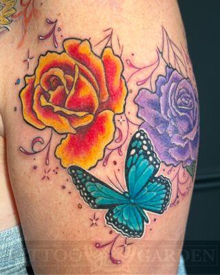 Classic roses and butterfly on upper arm.