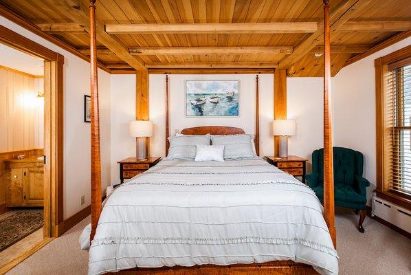 The Helmsman Quarters is a spacious room with ocean views. A queen size bed made from Tiger Maple wood.