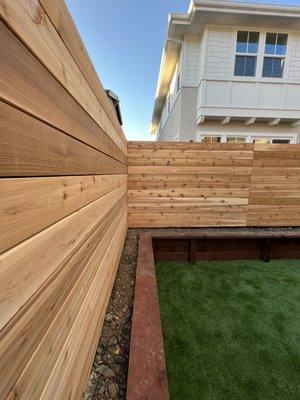 Decorative redwood fence work and wood retainer wall