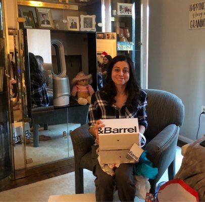 My daughter, opening her Crate and Barrel stemware.