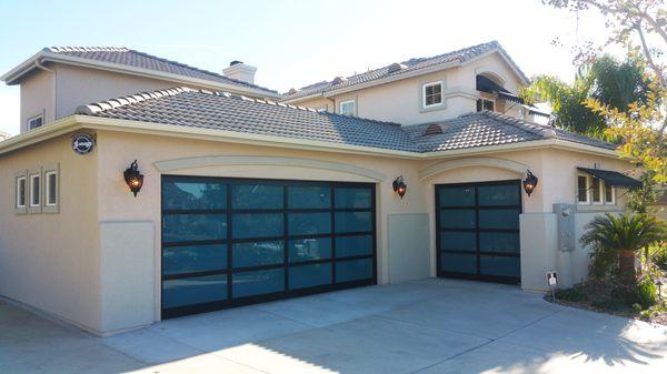 Full view glass garage door with aluminum frame and  blue tinted glass