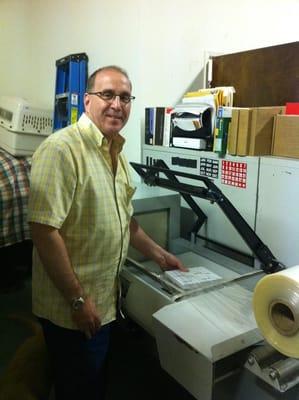 Here is a photo of Jeff operating the shrink-wrapper. We can package your order in any amounts of sheets your heart desires...