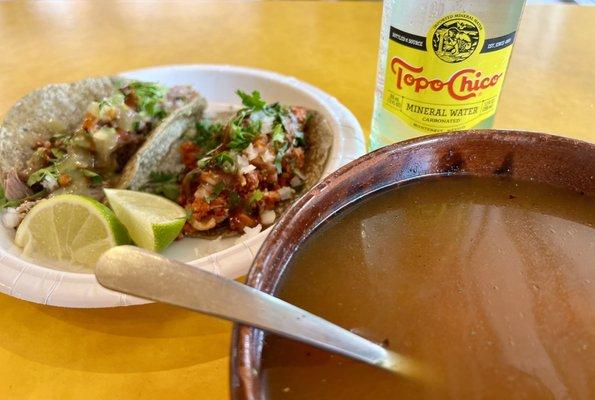 Barbacoa and Pancita tacos, mineral water, consomé. DELICIOUS.