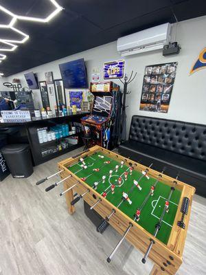 Arcade and foosball table inside barbershop