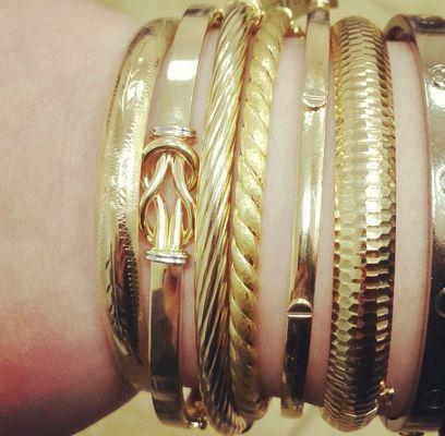 14k gold bangles, beautifully stacked.