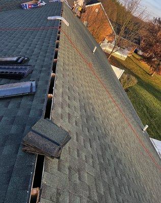 Ridge vent cut out for attic ventilation.