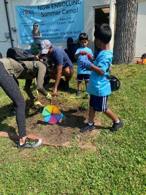 Stars students working on their family plot in our community garden