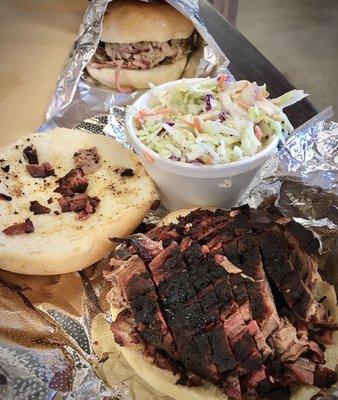 Pulled pork in the background, with brisket and coleslaw in front.