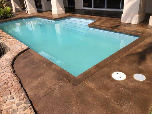 Kaanapali Maui Hi. Concrete pool deck, stained and sealed. Specialty coating. Decorative saw cut boarder.