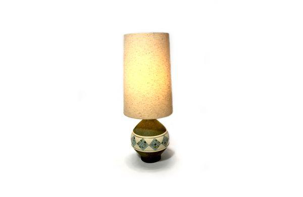 Mid-Century Green ceramic Table Lamp with circular wood base. Has small blue and green tiles around the center. White fabric shade.