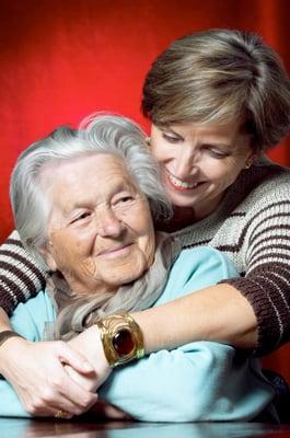 Daughter Hugging Elderly Mom who needs in home care.