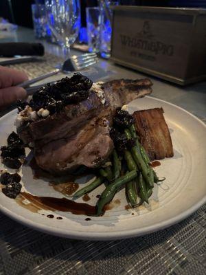 Pork chop with goat cheese and cherry compote with green beans and potato a-gratin