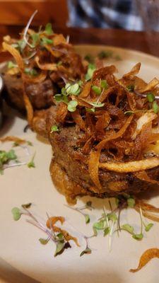 Meatloaf with smashed potatoes, micro greens and onion ribbons.