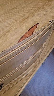 Deep gouge in antique dresser.