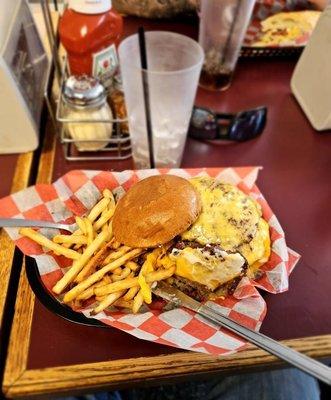 Triple patty cheeseburger deluxe.