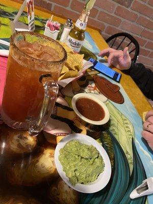 Michelada, guacamole, salsa, chips and Modelo