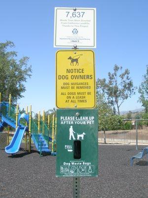 sign and dog bags the man could have used to pick up after his dog