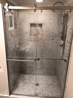 Customer marble tile shower with a mosaic shower pan. A timeless design, with modern accents.