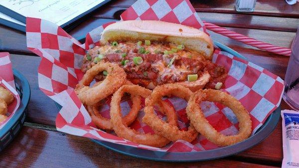 Polish sausage topped with chili served with onion rings