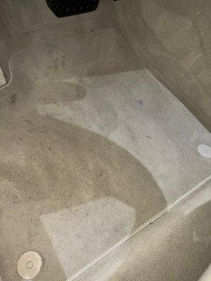 Driver floor mat with dirty shoe prints