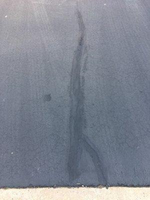 See how bad the crack was filled in the driveway.