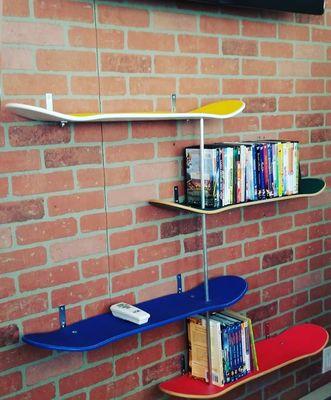 Created wall book shelves using unused skateboards