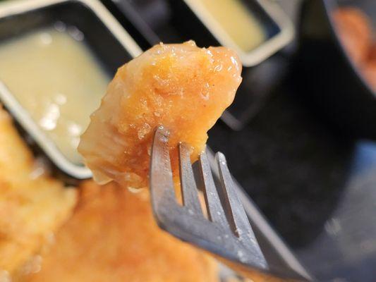 A piece of the Pork Chop  on a fork.