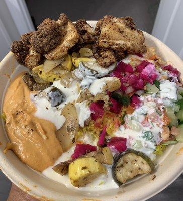 Rice Bowl, Grilled Veggies, Baba Ganoush Hummus, Spiced Cauliflower, Tomato & Cucumber, Cabbage Slaw, Pickled Turnips, and Garlic Sauce