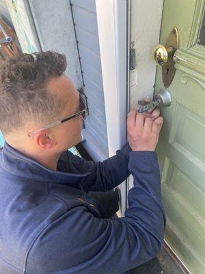 Unlocking a deadbolt lock on a customers back door.