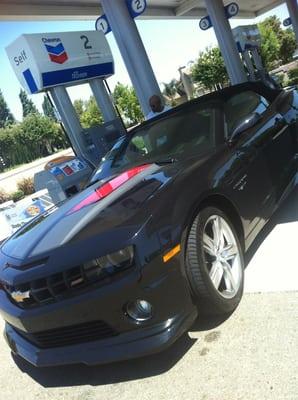 Gassing up the convertible Maro he named "Miranda" from Mass Effect! Smh! Lol