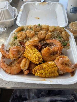 Cajun shrimp boil with shrimp fried rice.